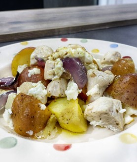 Plate of chicken, red potatoes, red onions, feta
